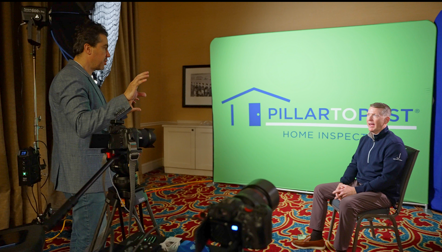 Onsite corporate interview production with branded backdrop and professional studio lighting