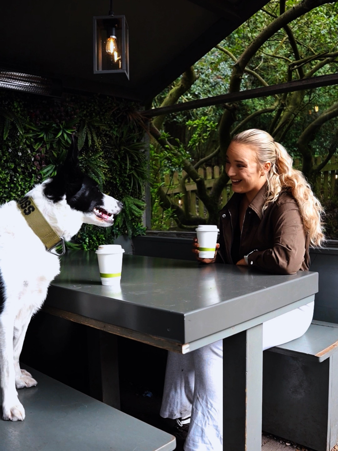 Ally, founder of Ally's Dogs, at a dog-friendly cafe with her dog during a community meetup