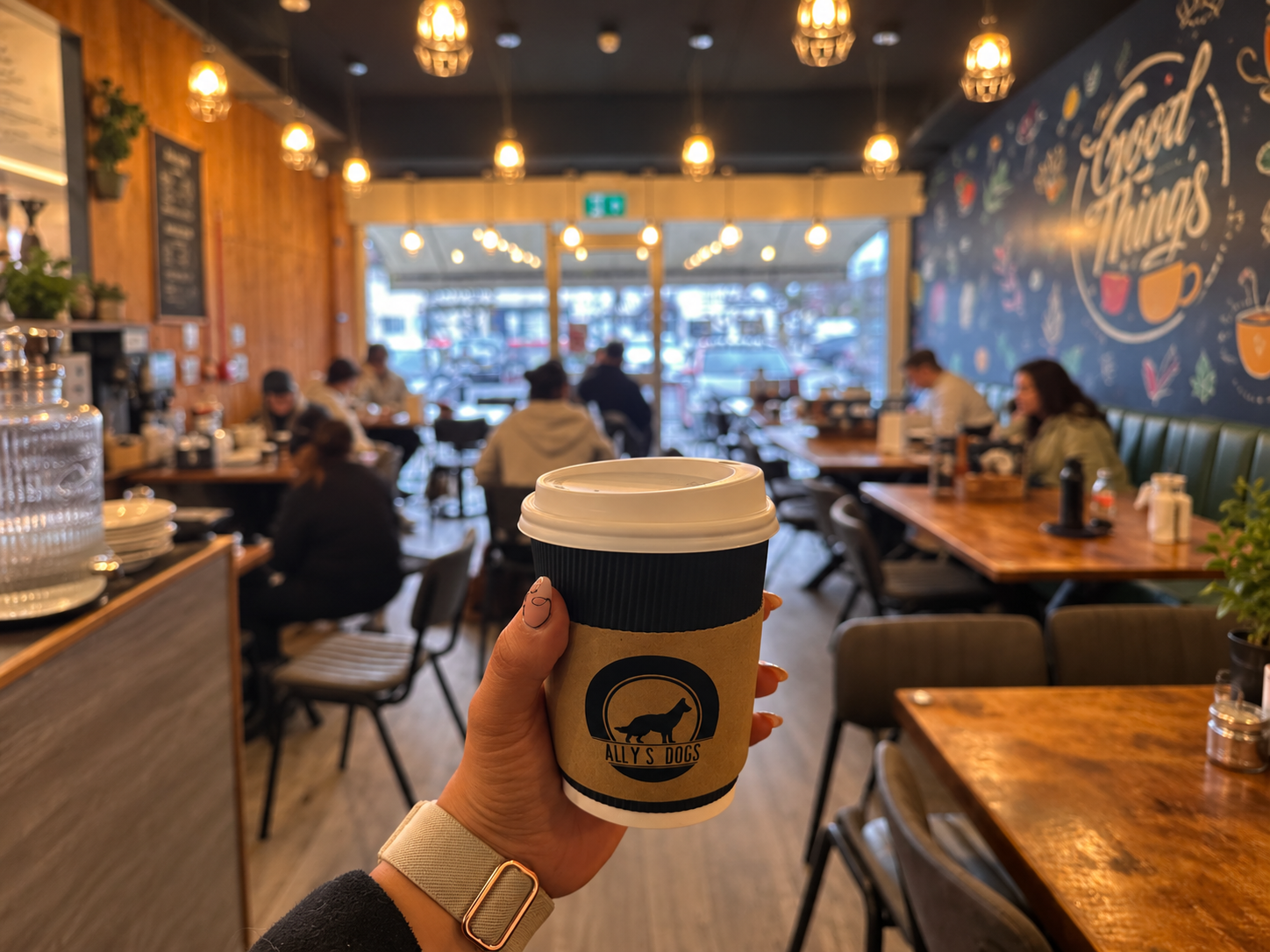 Ally's Dogs coffee cup and community social meetup in a dog-friendly cafe