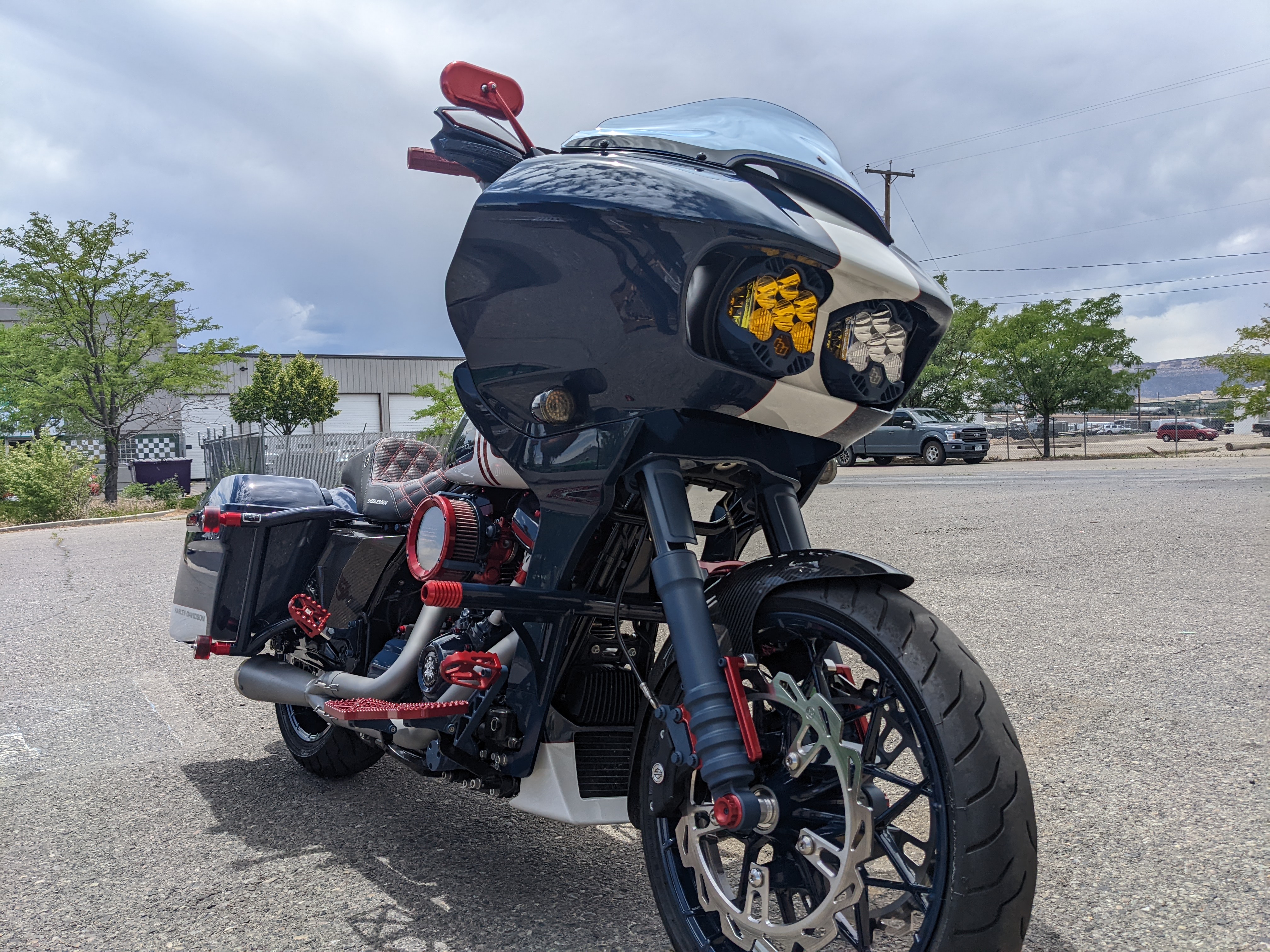 Custom Harley-Davidson motorcycle with candy red powder coated accents, pegs, and engine trim