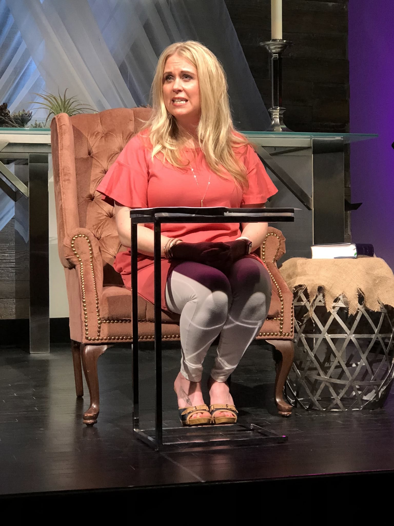 Dr. Laura Fleetwood teaching on stage in fireside setting