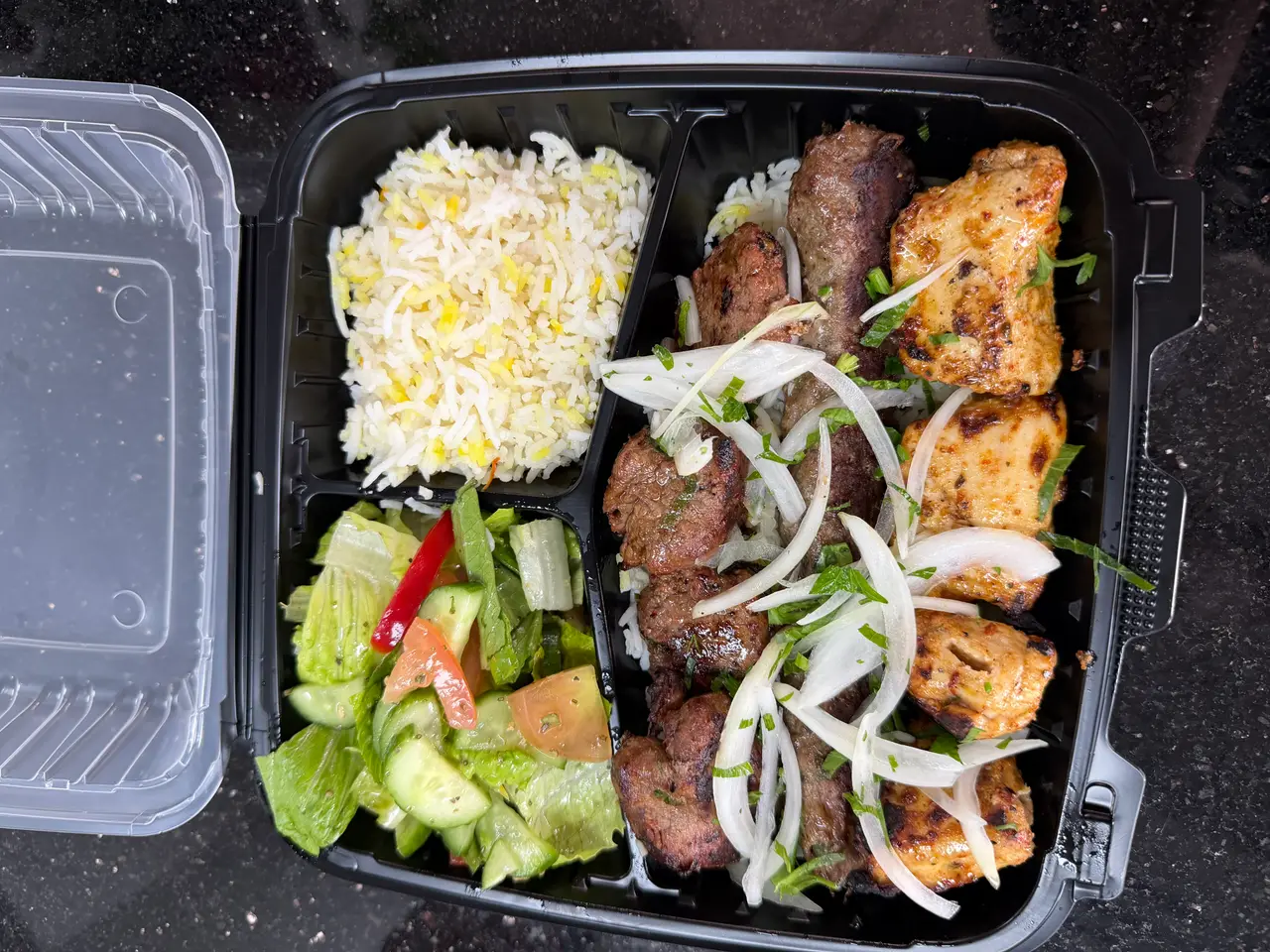 Fresh shawarma and prepared foods at Hala Market Sugar Land restaurant counter