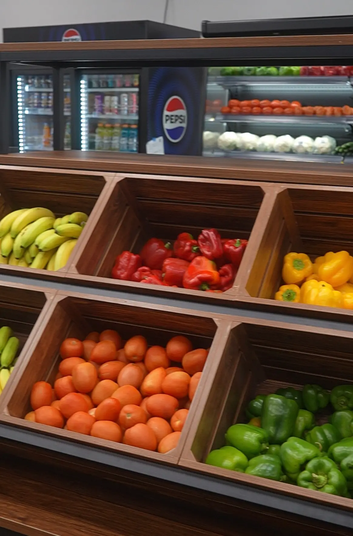 Fresh produce aisle at Hala Market Sugar Land with peppers, tomatoes and bananas