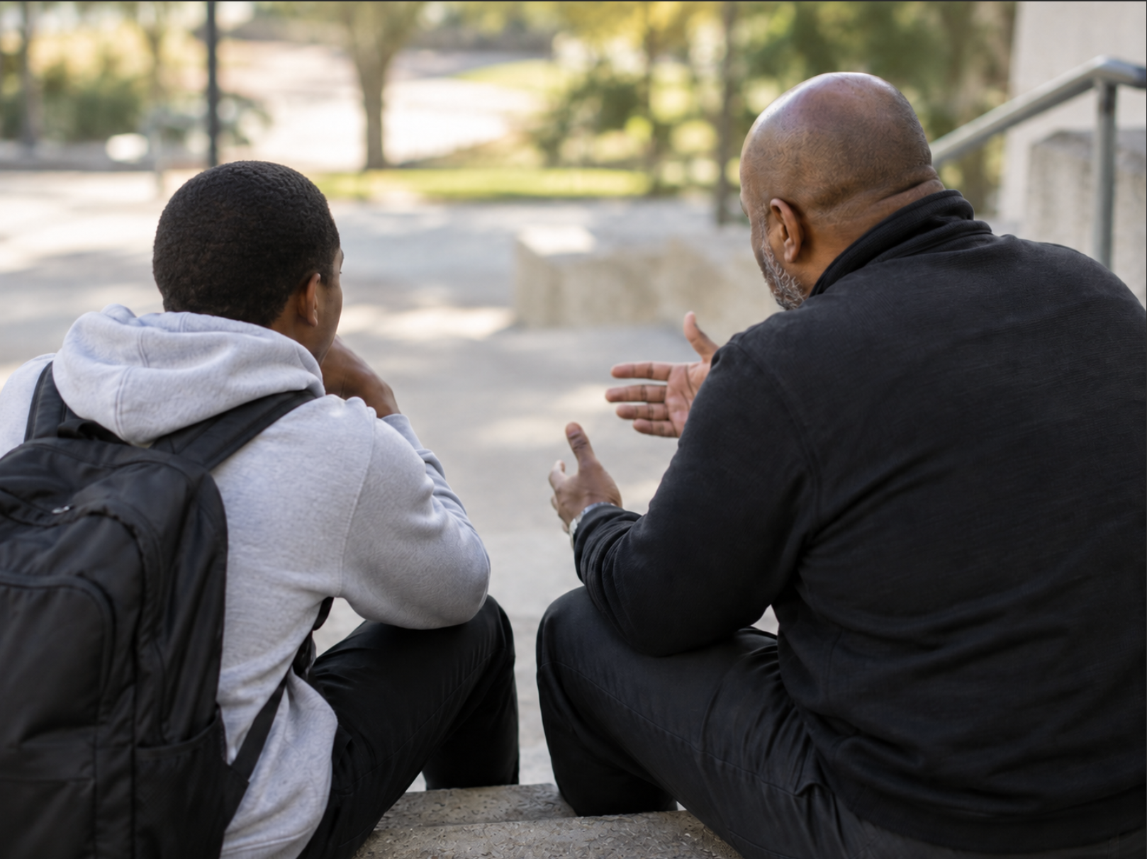 Mentor providing guidance and support to a young man