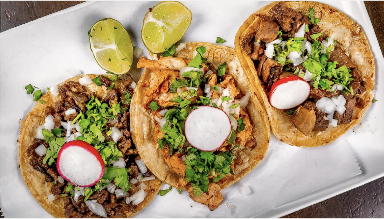 Authentic street-style tacos on corn tortillas with cilantro and lime