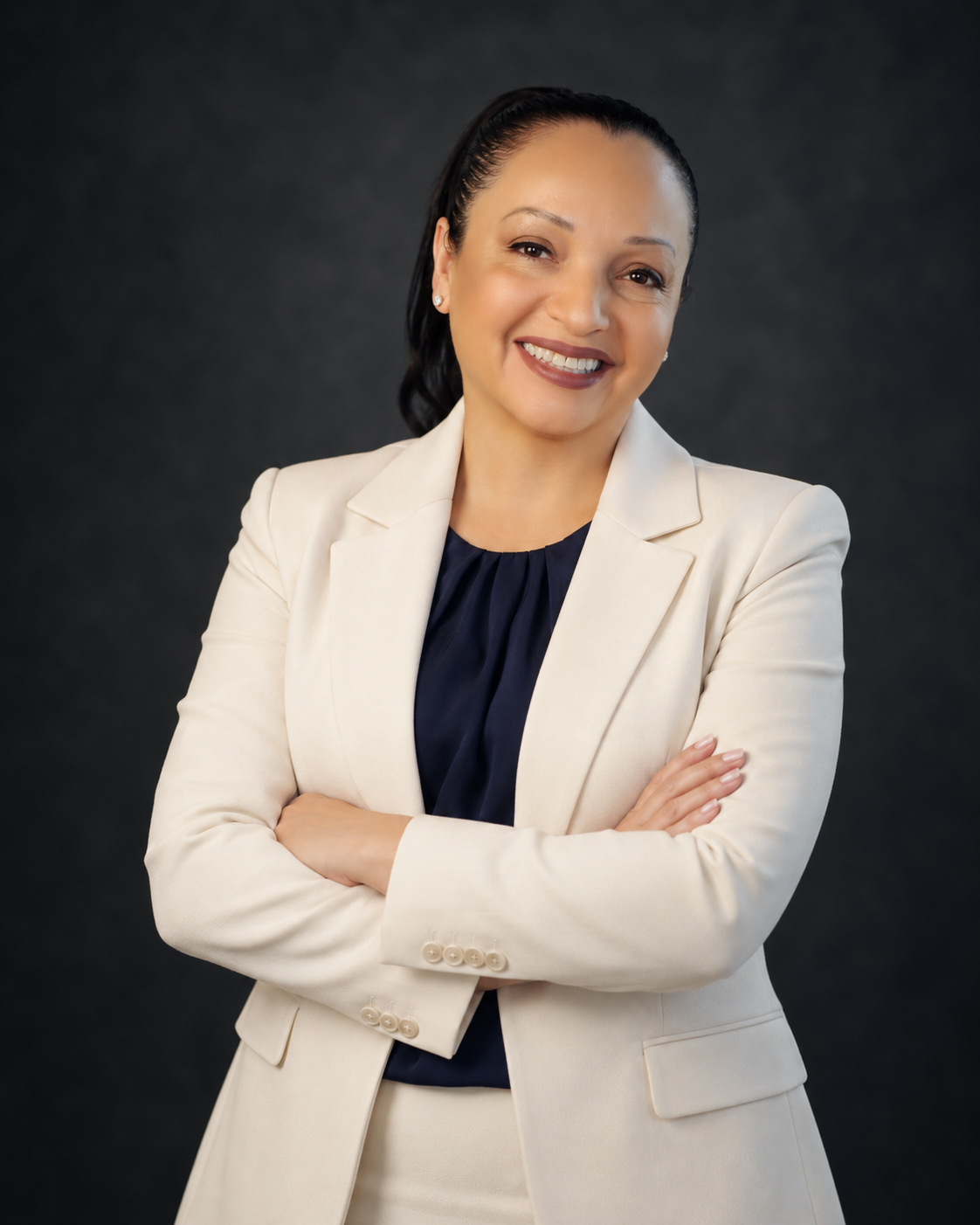 Margarita Santiago, founder and med spa business advisor at Med Spa Scale Systems, smiling portrait in white suit