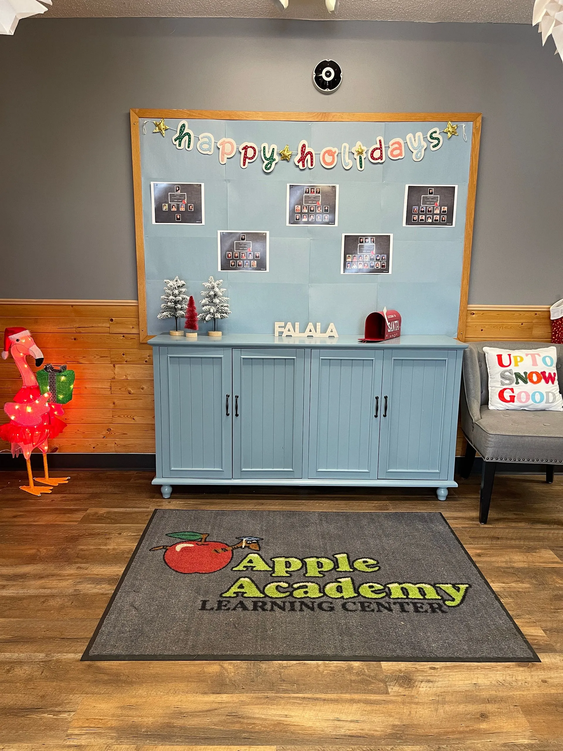 Apple Academy Learning Center welcoming entryway and lobby area with holiday decorations and classroom board