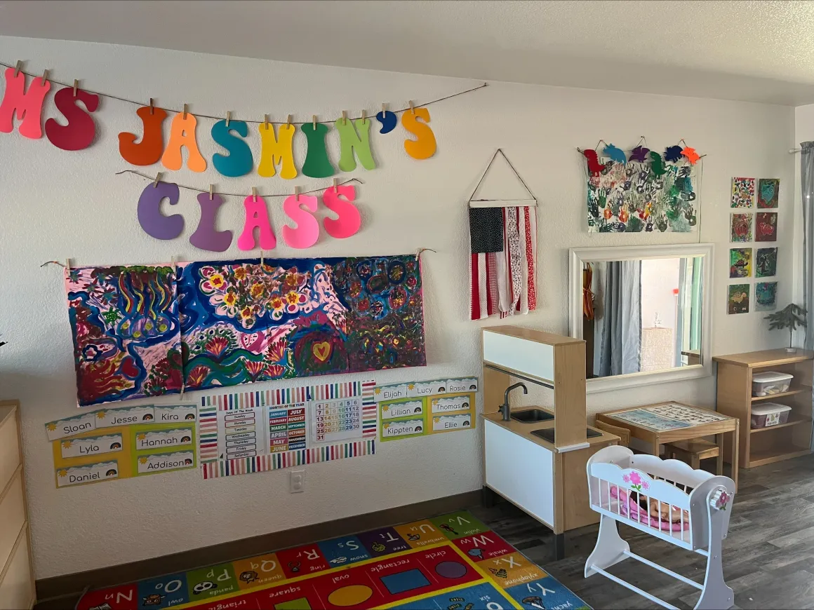 Early childhood classroom with dramatic play center and student art wall