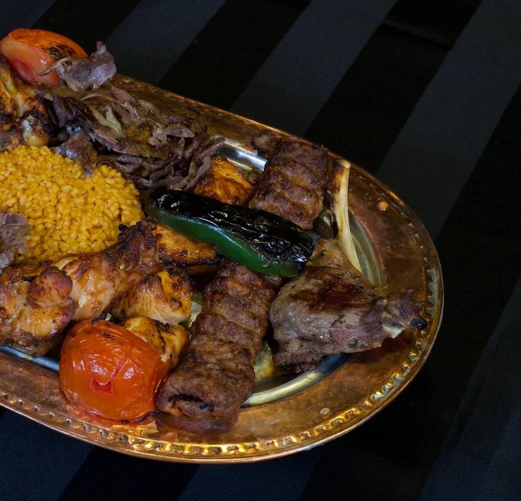 A copper platter of authentic charcoal-grilled kebabs at Ziyafet