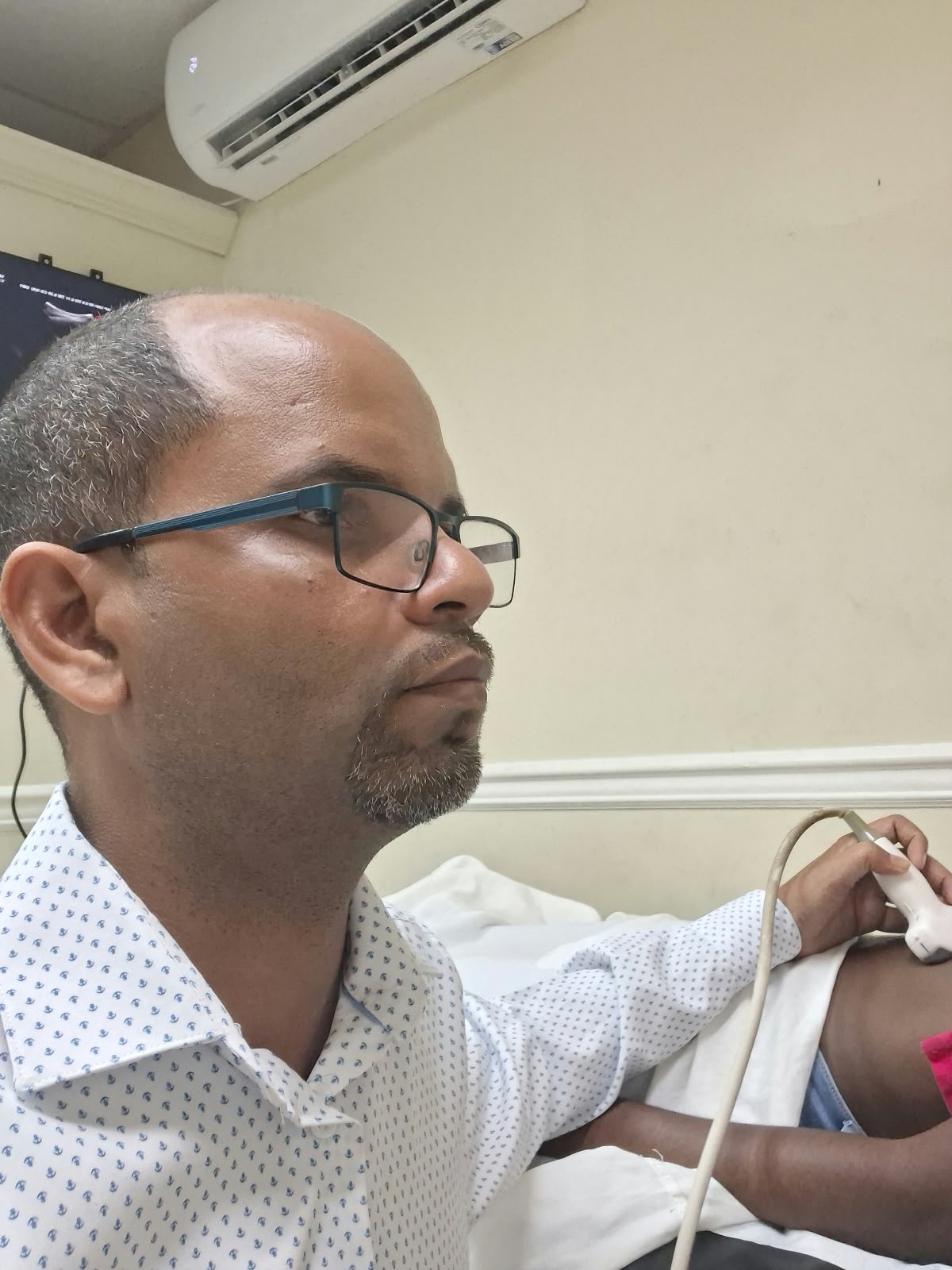 Dr. Christi Philogene performing an ultrasound examination at Precision Imaging