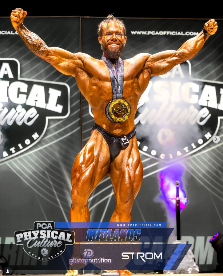 James Alabaster front double biceps victory pose with PCA gold medal