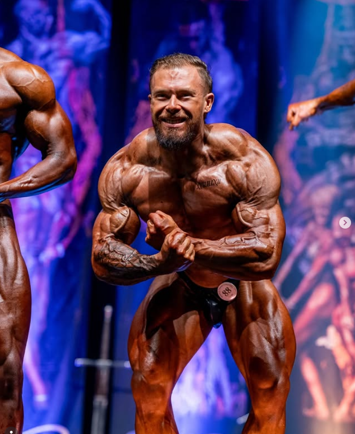 James Alabaster classic onstage side-arm / most muscular pose showing peak conditioning