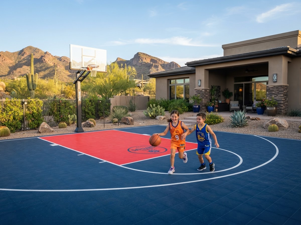 Children playing basketball on a colorful residential outdoor sport court with a navy surface and red key beside a modern home in Peoria, AZ