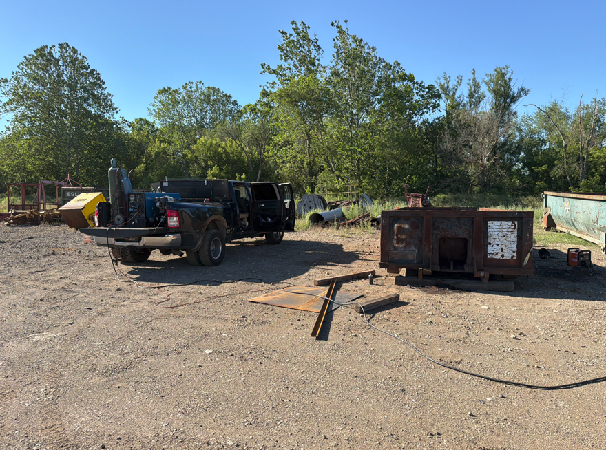 Mobile welding truck set up on site with the welder, gas bottles and leads run out to the work