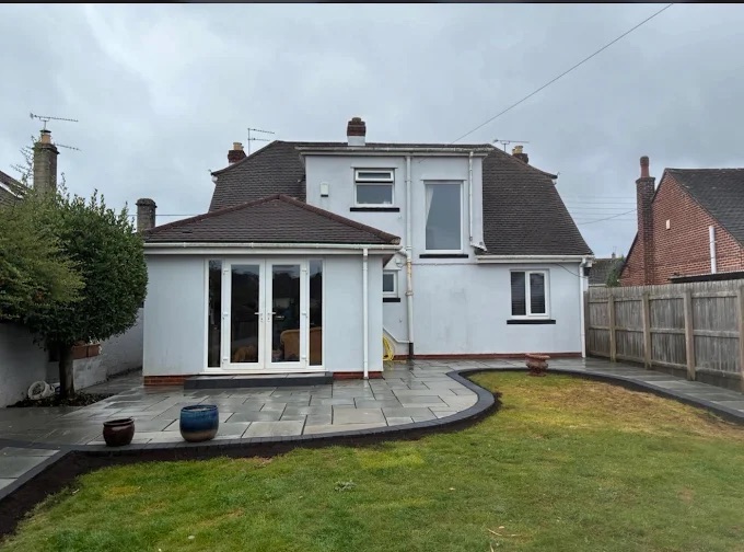 Full exterior roofline, white UPVC gutters and downpipes on extension