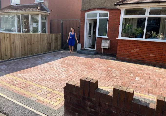 Completed front driveway in warm red block paving with perimeter kerb and decorative band