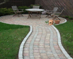 Imprinted concrete circular patio and curved garden walkway