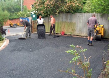 Professional tarmac laying and rolling in progress