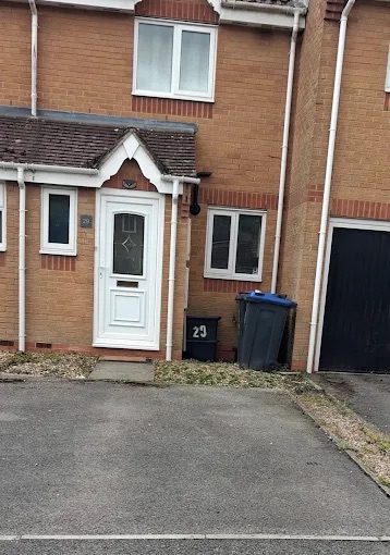 Tarmac front forecourt and residential parking area outside terraced property