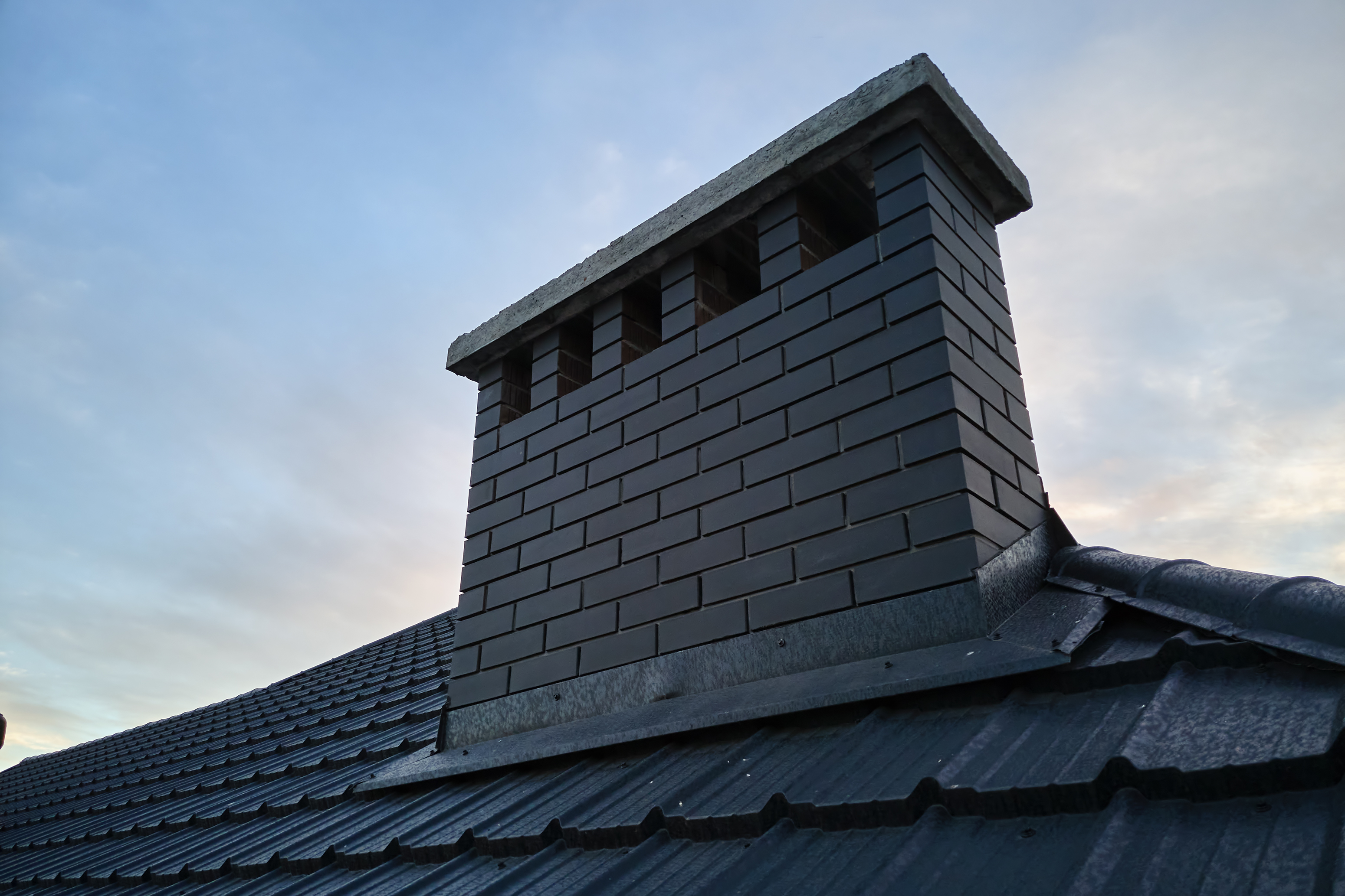 Newly repointed brick chimney stack with custom brick venting