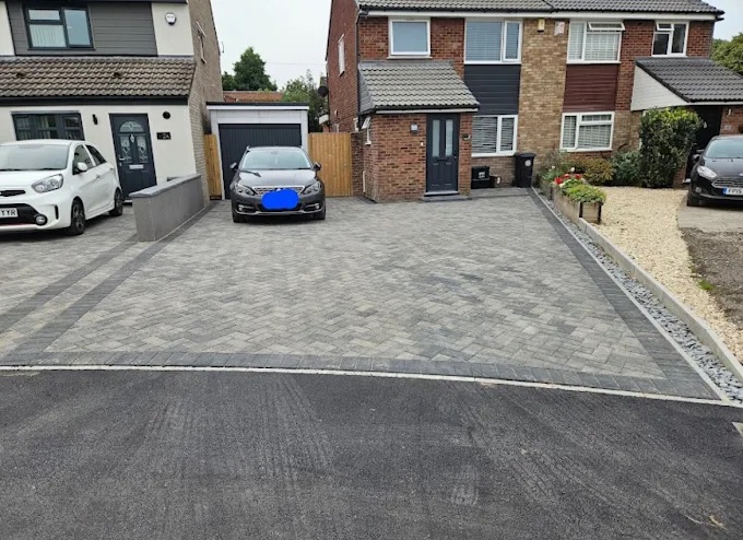 Silver-grey block paving driveway with charcoal border and gravel drainage border