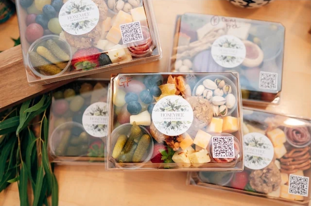 custom branded individual charcuterie boxes with dietary labels and QR codes for event catering