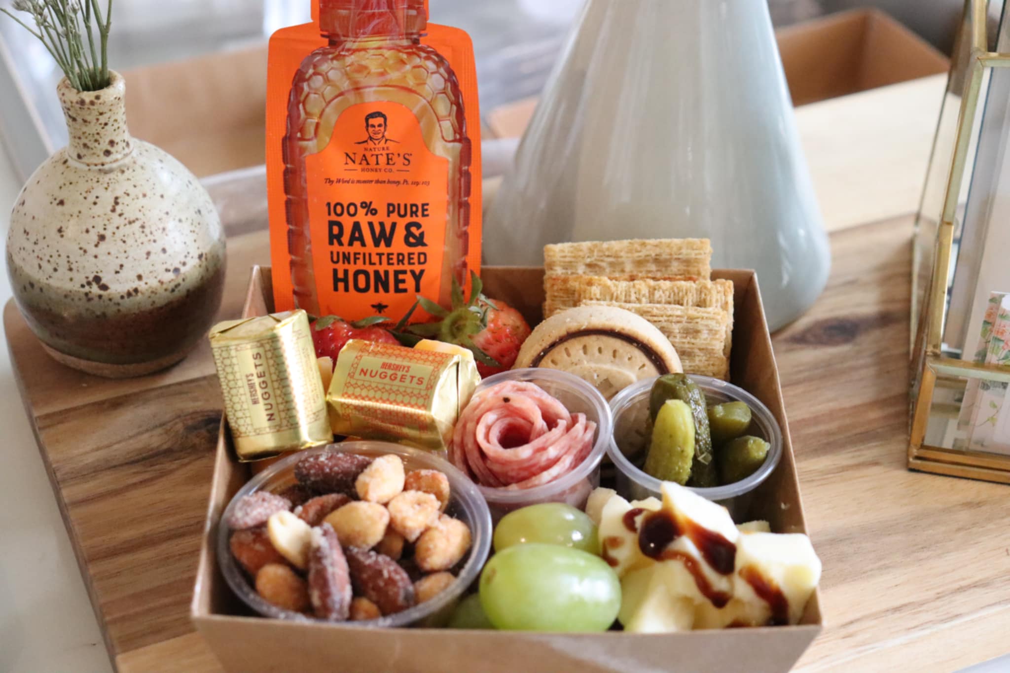 individual artisan charcuterie grazing box with raw honey pouch, salami rose, cheeses, fruit and nuts