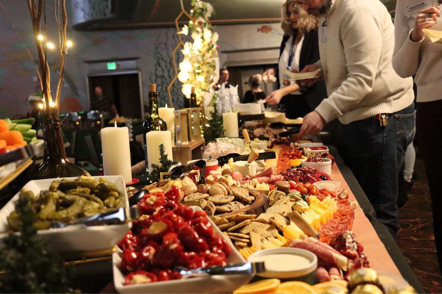 Honeybee Horticulture luxury charcuterie grazing table with candles, fresh vegetables, cheeses and cured meats for corporate event catering in Kitsap County