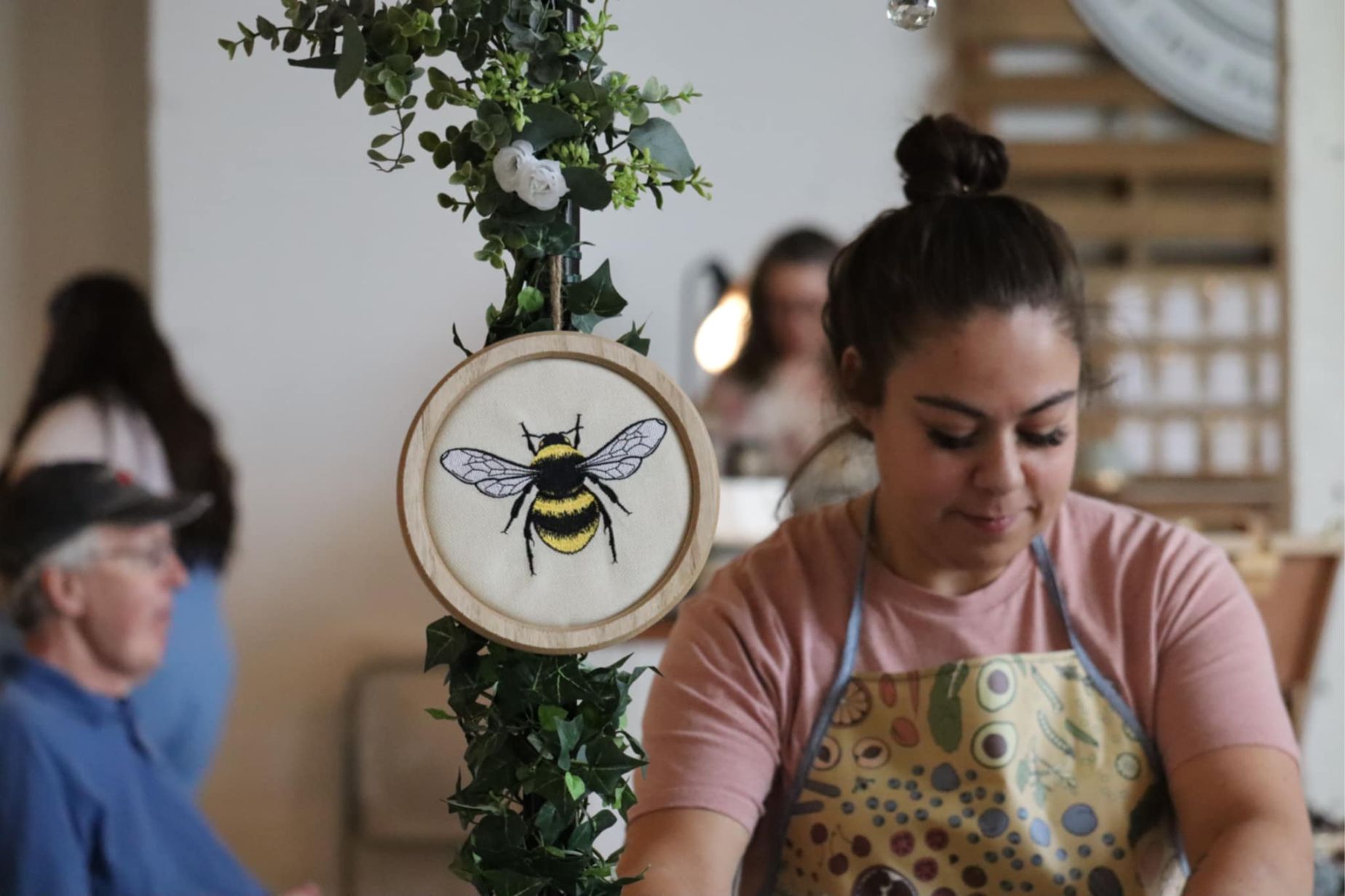 Honeybee Horticulture bumblebee branding with custom embroidery and fresh greenery decor