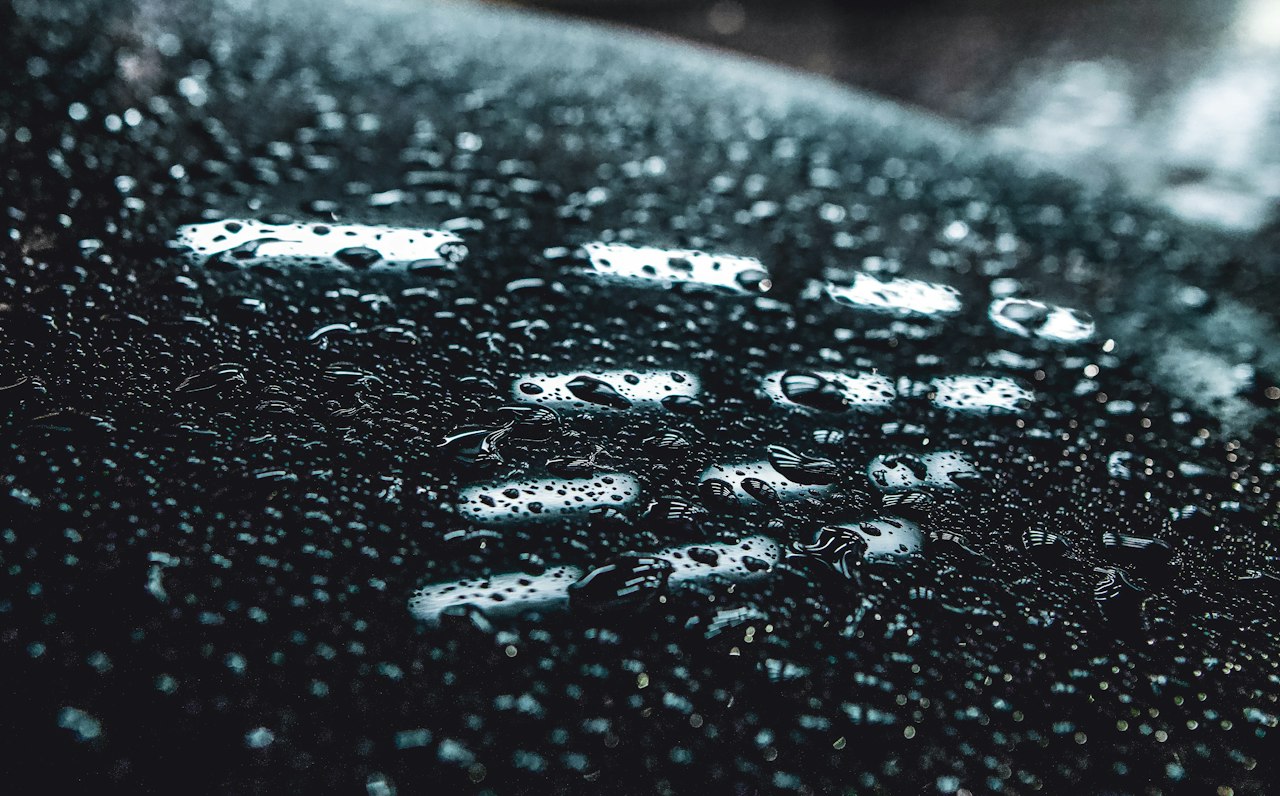 Water beading on a ceramic-coated paint surface, showing hydrophobic protection