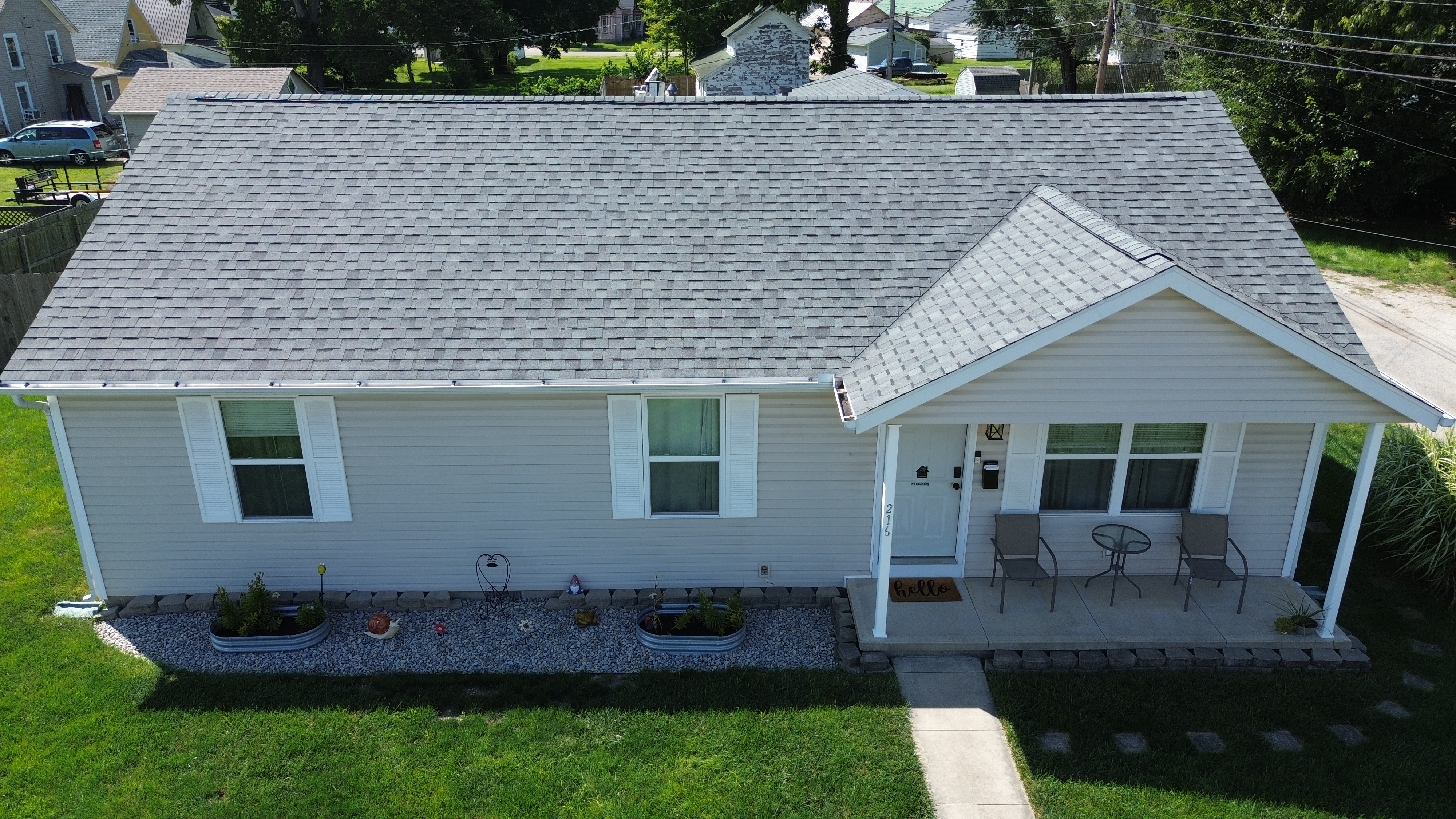 Aerial view of completed residential roof tear-off and new gutters