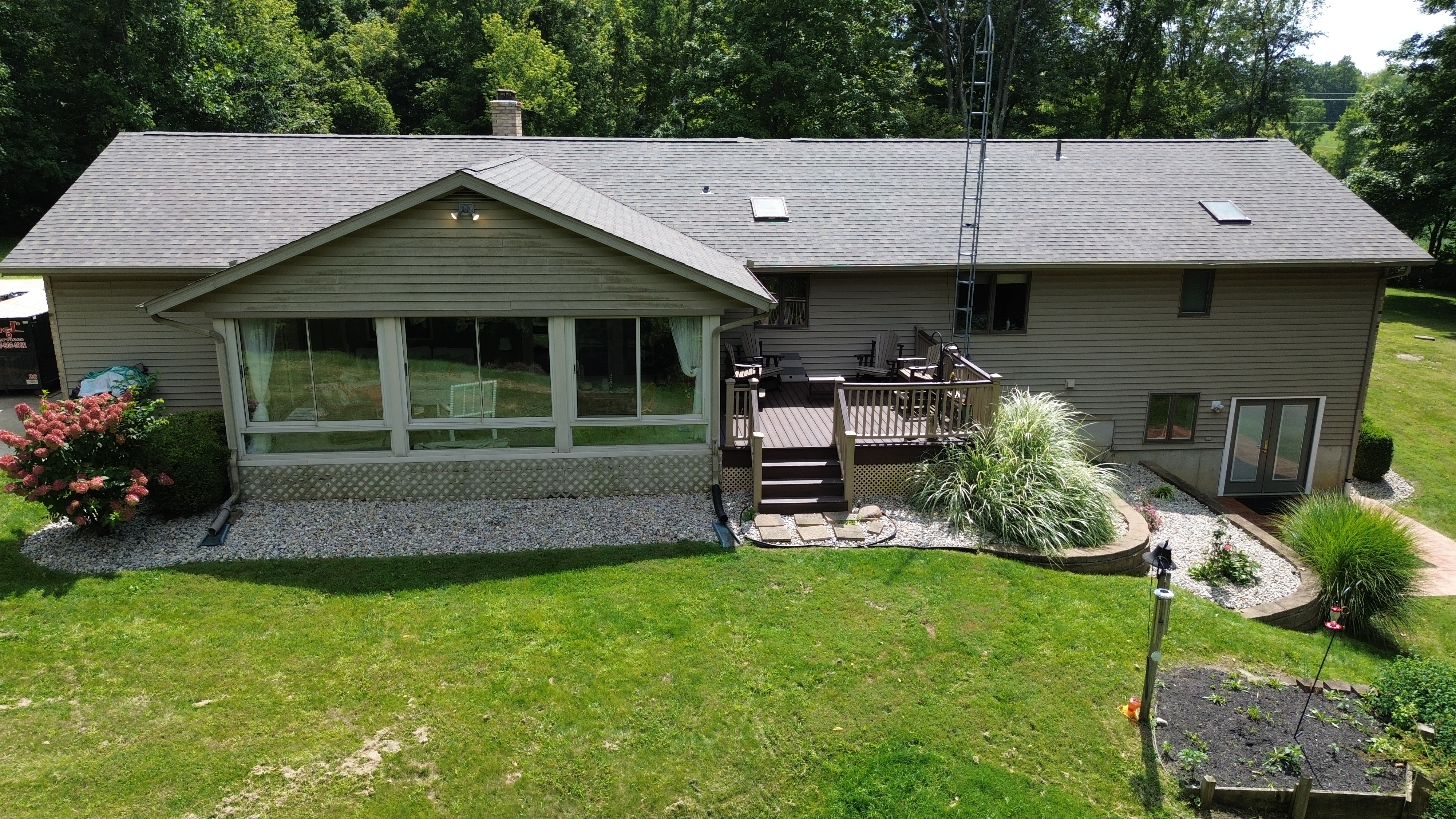 Aerial drone view showing skylights, chimney flashing and clean roof lines