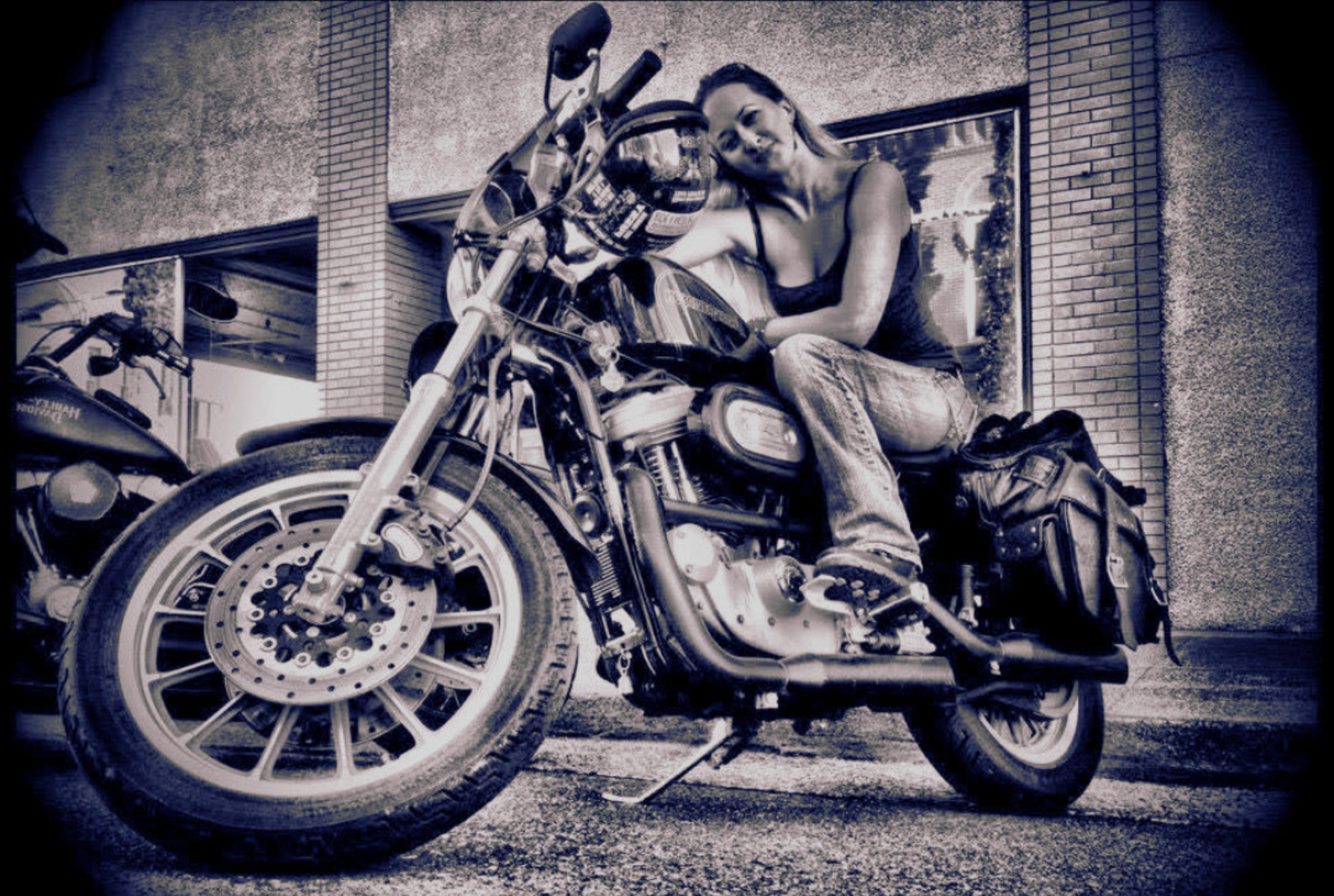 Motorcycle rider sitting on a Harley-Davidson outside the brick exterior of Wildhorse Bar & Grill