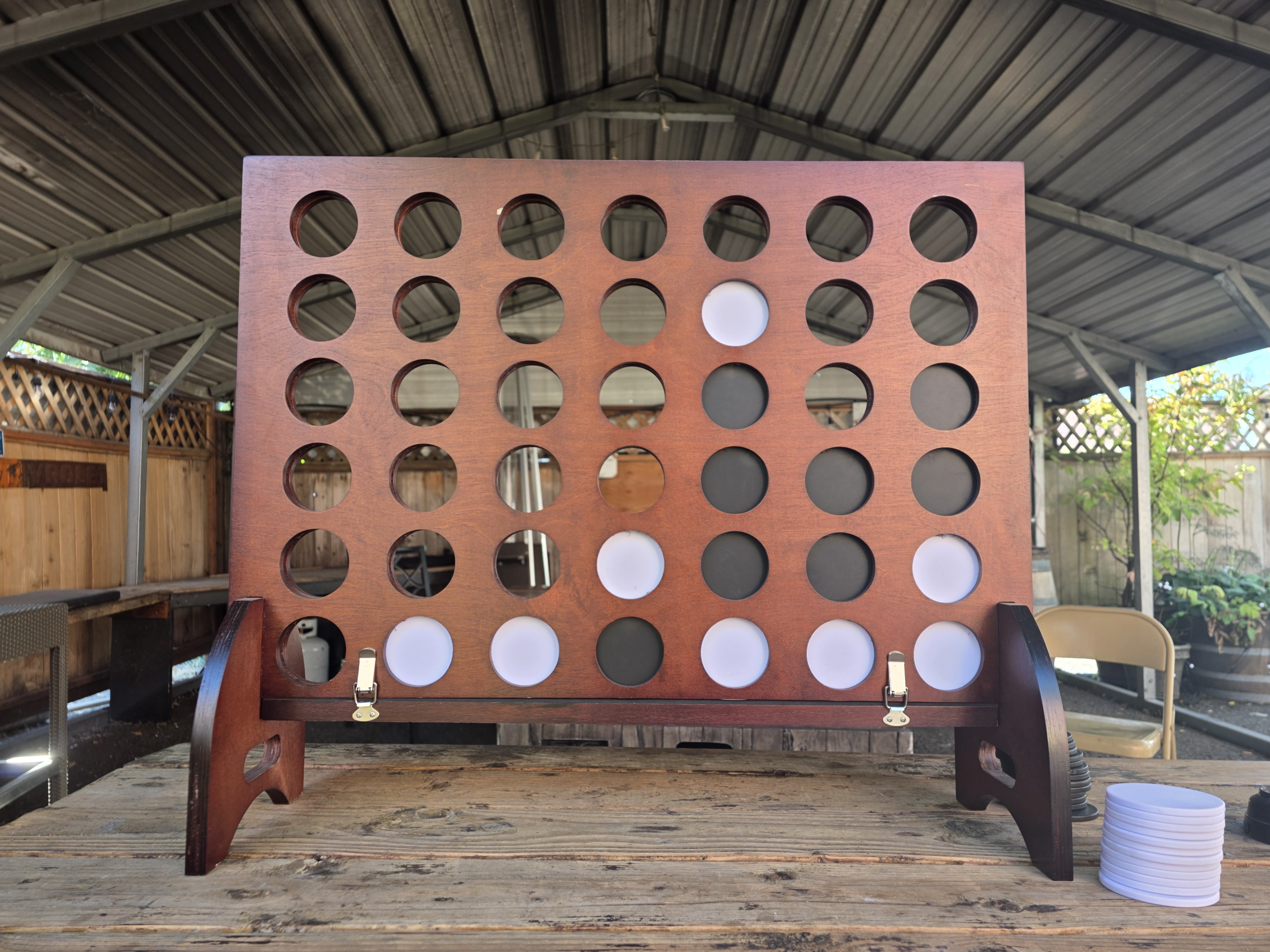 Wildhorse Bar & Grill giant wooden Connect Four game on a rustic picnic table
