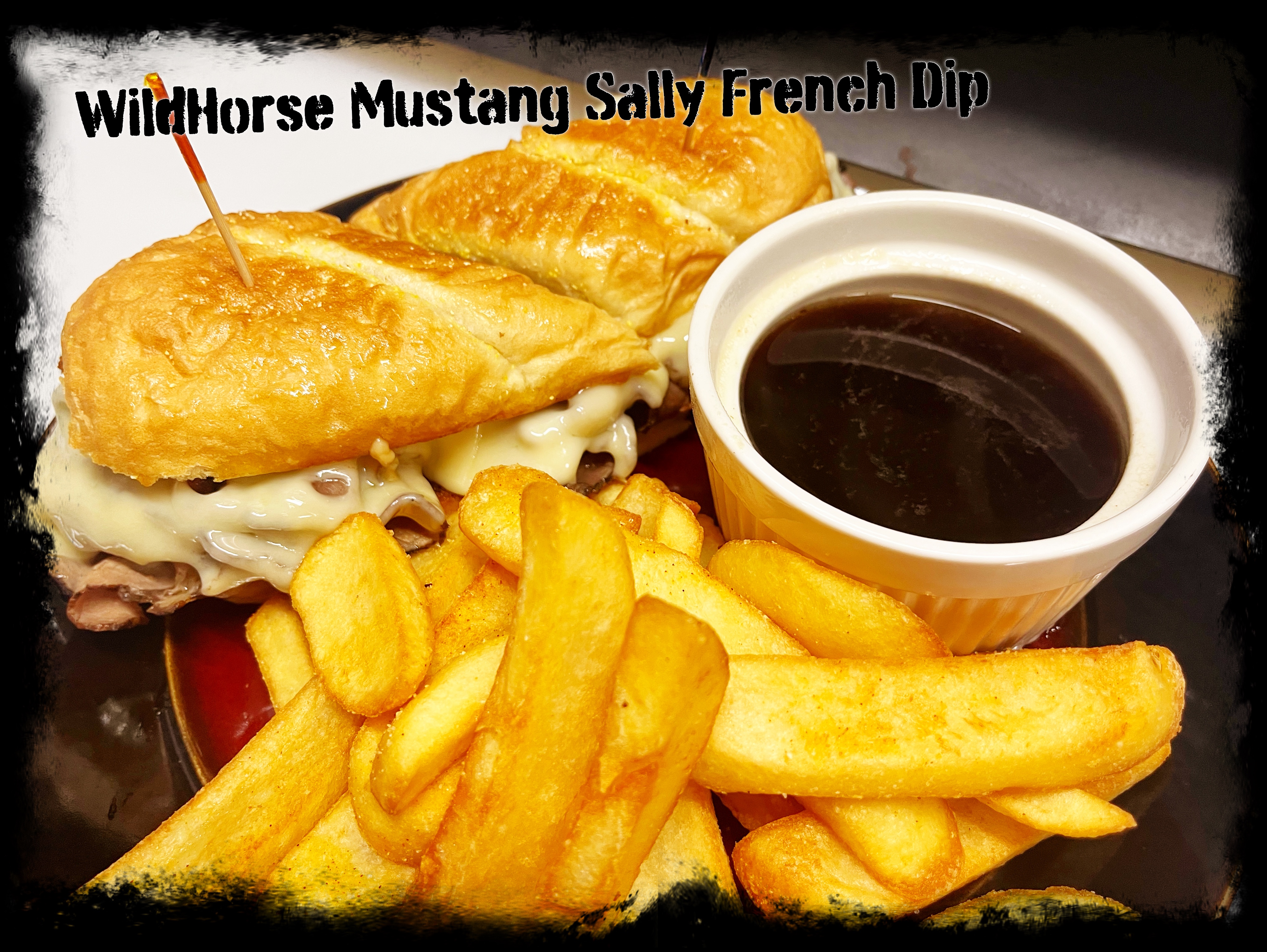 Wildhorse Mustang Sally French Dip sandwich with melted Swiss cheese, savory roast beef on a toasted roll, au jus dipping sauce, and golden steak cut fries