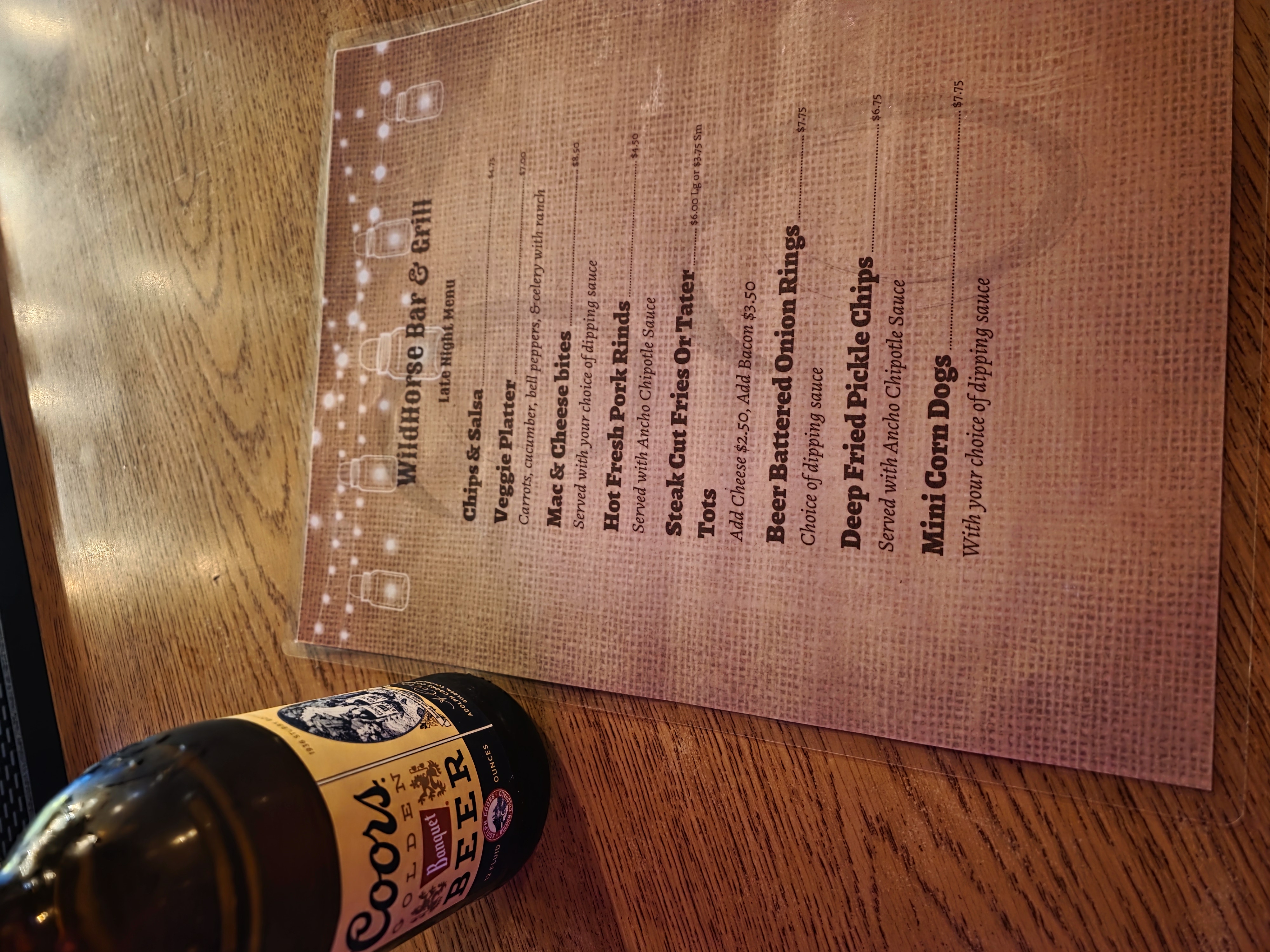 Wildhorse Bar & Grill late-night menu on a wooden bar.