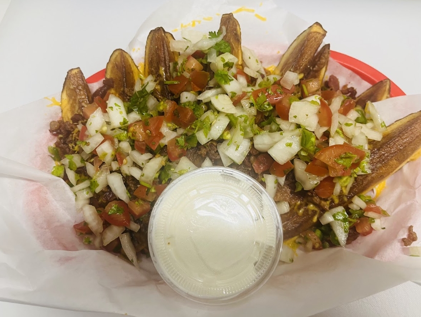 Wildhorse Bar & Grill crispy fried potato skins loaded with melted cheese, bacon, fresh pico de gallo, and a cup of sour cream in a basket