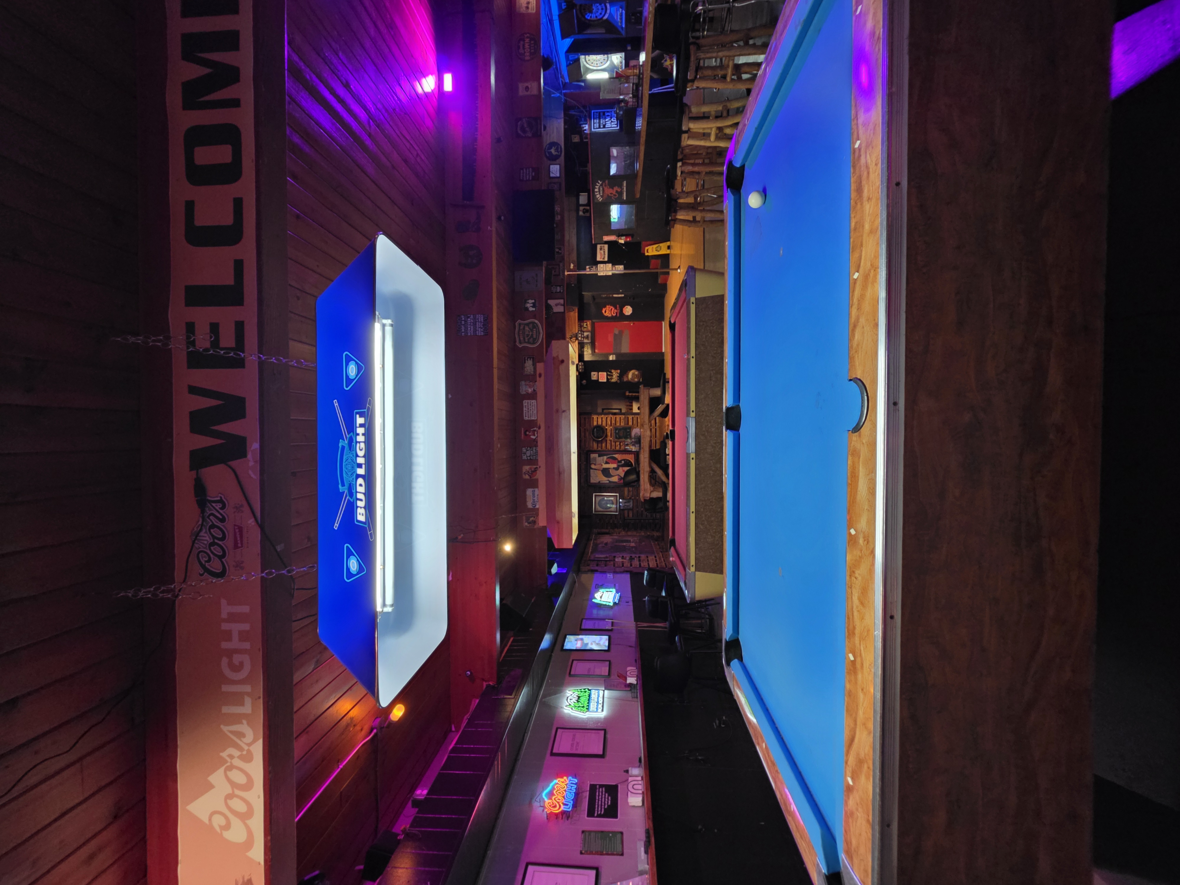 Wildhorse Bar & Grill pool room with blue felt pool tables under Bud Light billiard lights