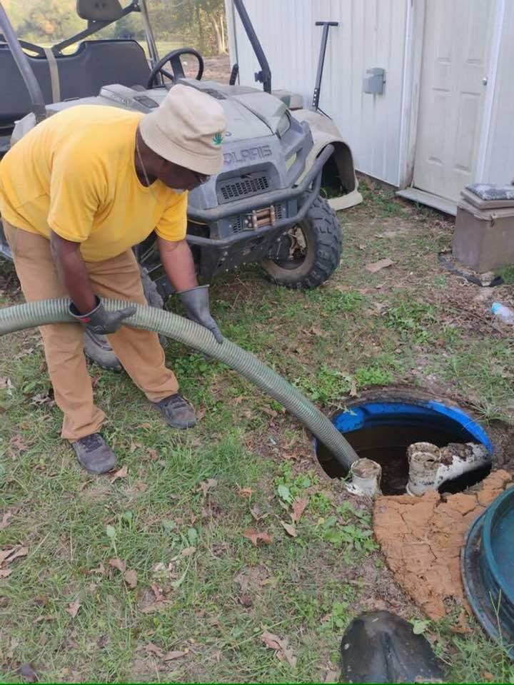 Rosier technician pumping underground septic tank on site