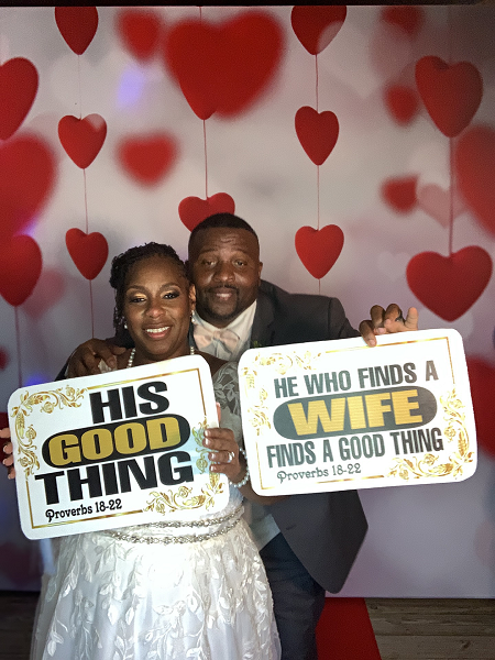 Bride and groom posing at an Elite360 wedding photo booth