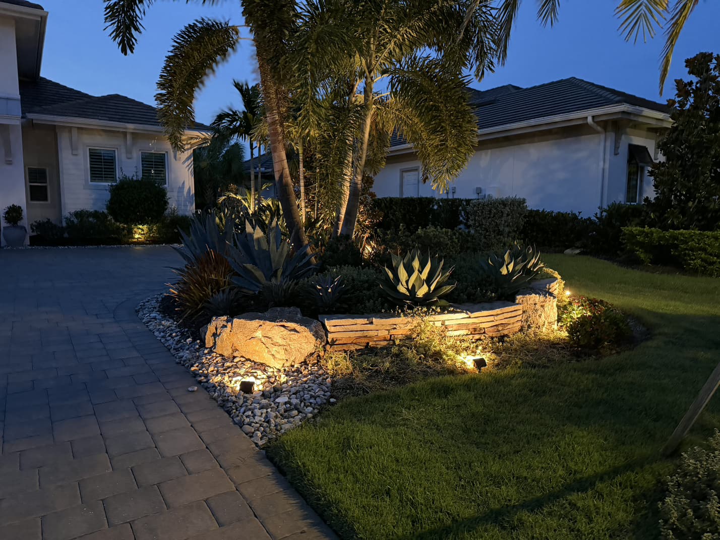 warm LED outdoor landscape lighting along driveway stone garden in Lakewood Ranch FL