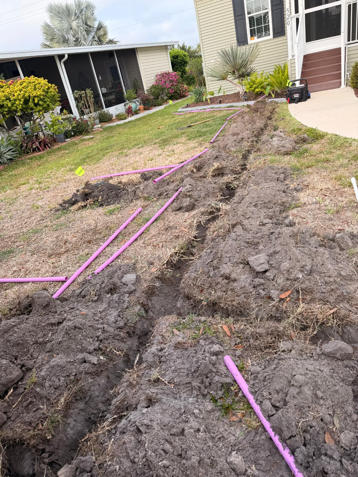 residential front yard irrigation trenching and purple sprinkler pipe installation by Aenlle Home Service LLC