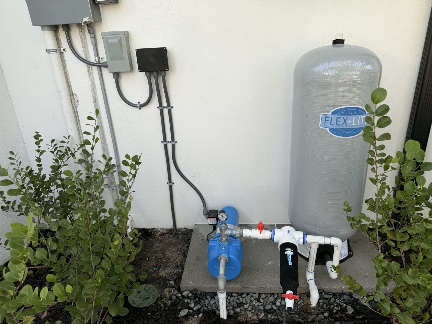 complete outdoor irrigation well pump station with spin-down filter and Flex-Lite pressure tank installed by Aenlle Home Service LLC