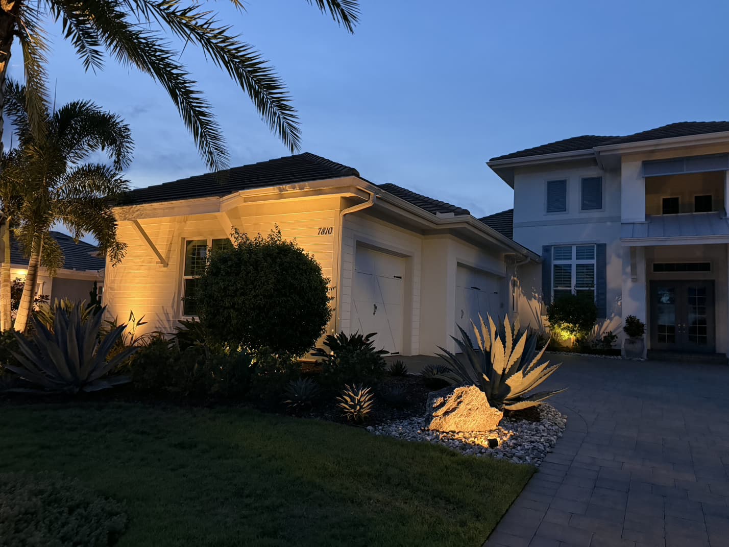 architectural exterior wall wash lighting and illuminated agave boulder by Aenlle Home Service LLC
