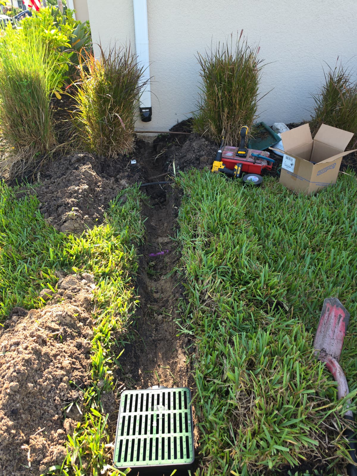 gutters downspout adapter trench connection into green lawn surface catch basin grate