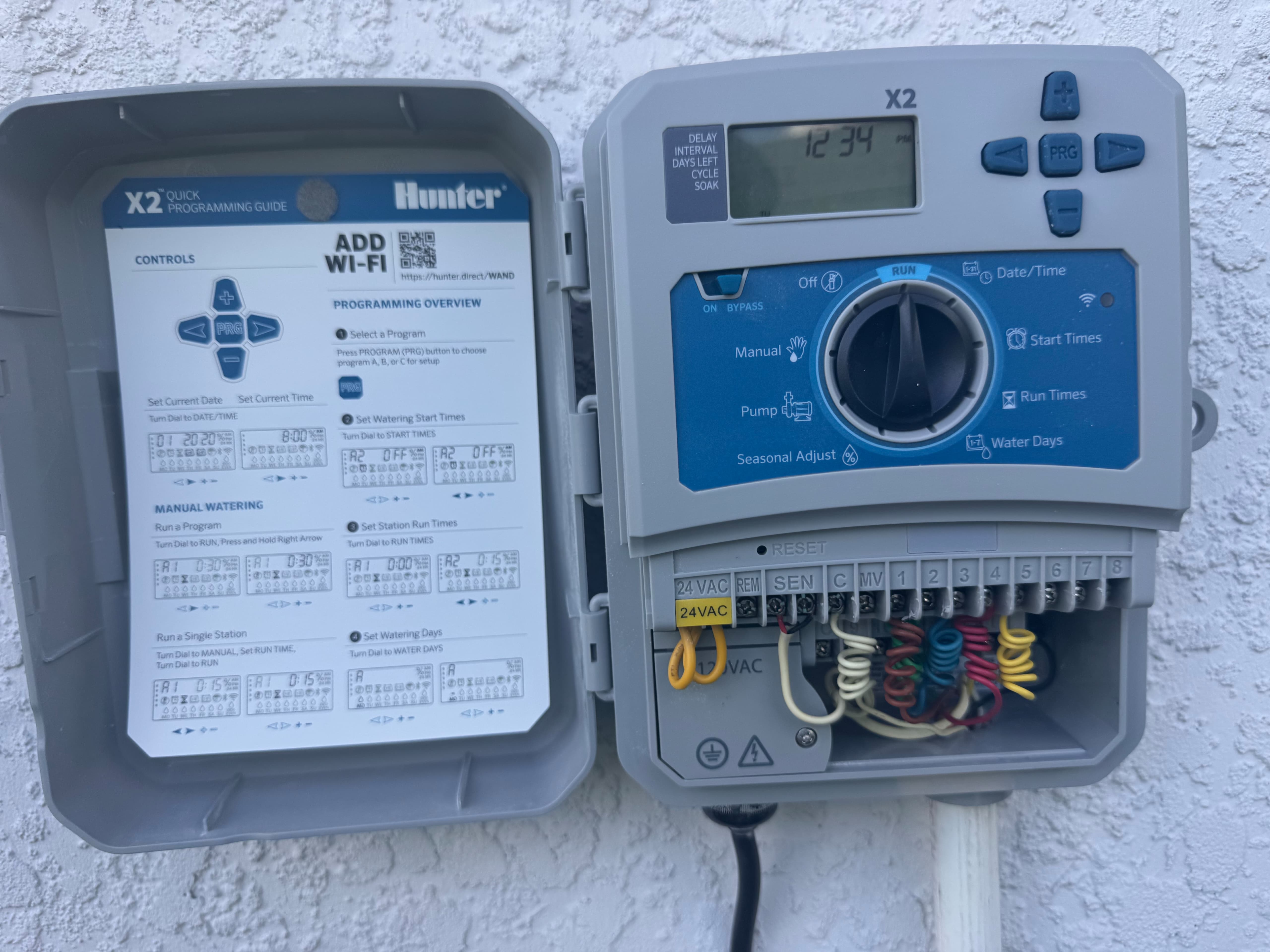 new Hunter X2 outdoor irrigation controller with neat color-coded multi-zone solenoid wiring by Aenlle Home Service LLC