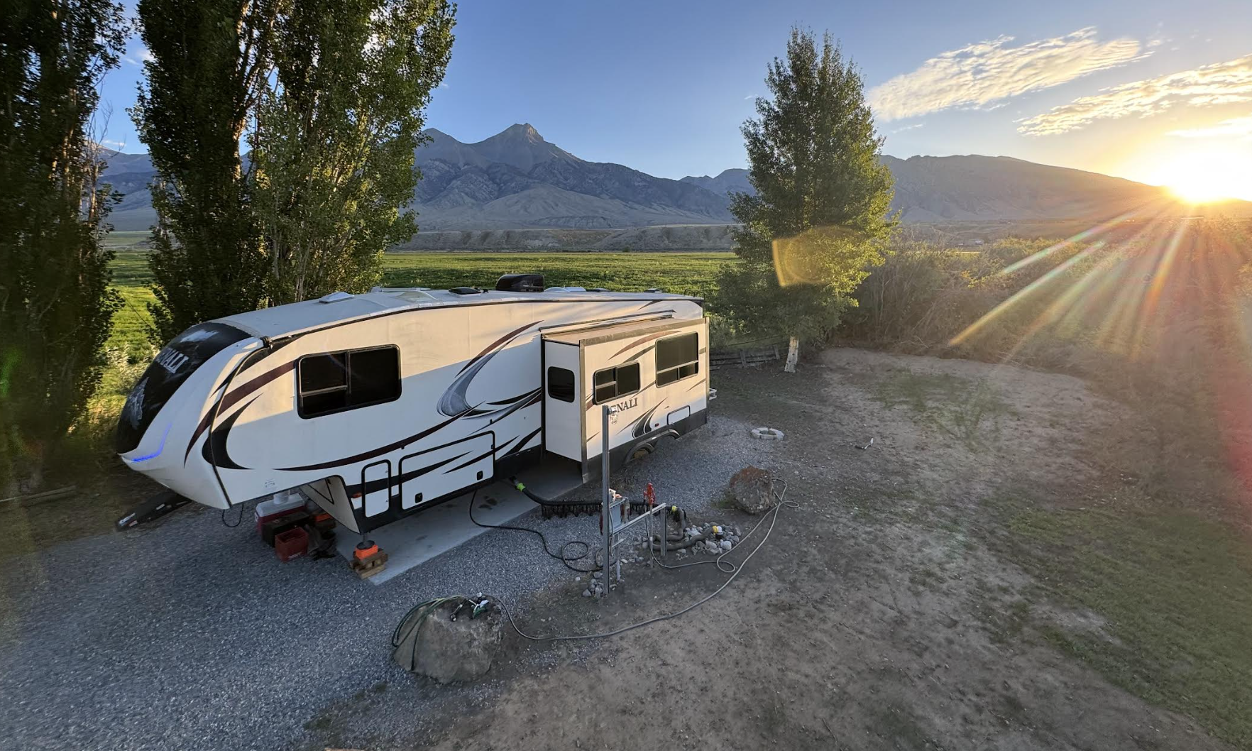 RV pad with full hookups and a sunset view over the mountains