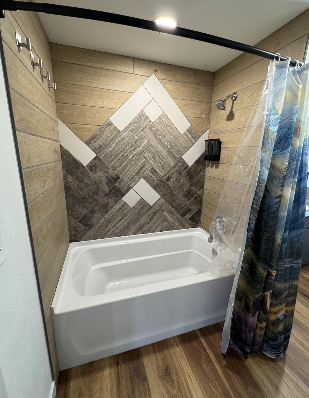 Custom mountain peak chevron tile design over the bathtub