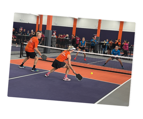 Players competing in an intense pickleball match at Pickleplex