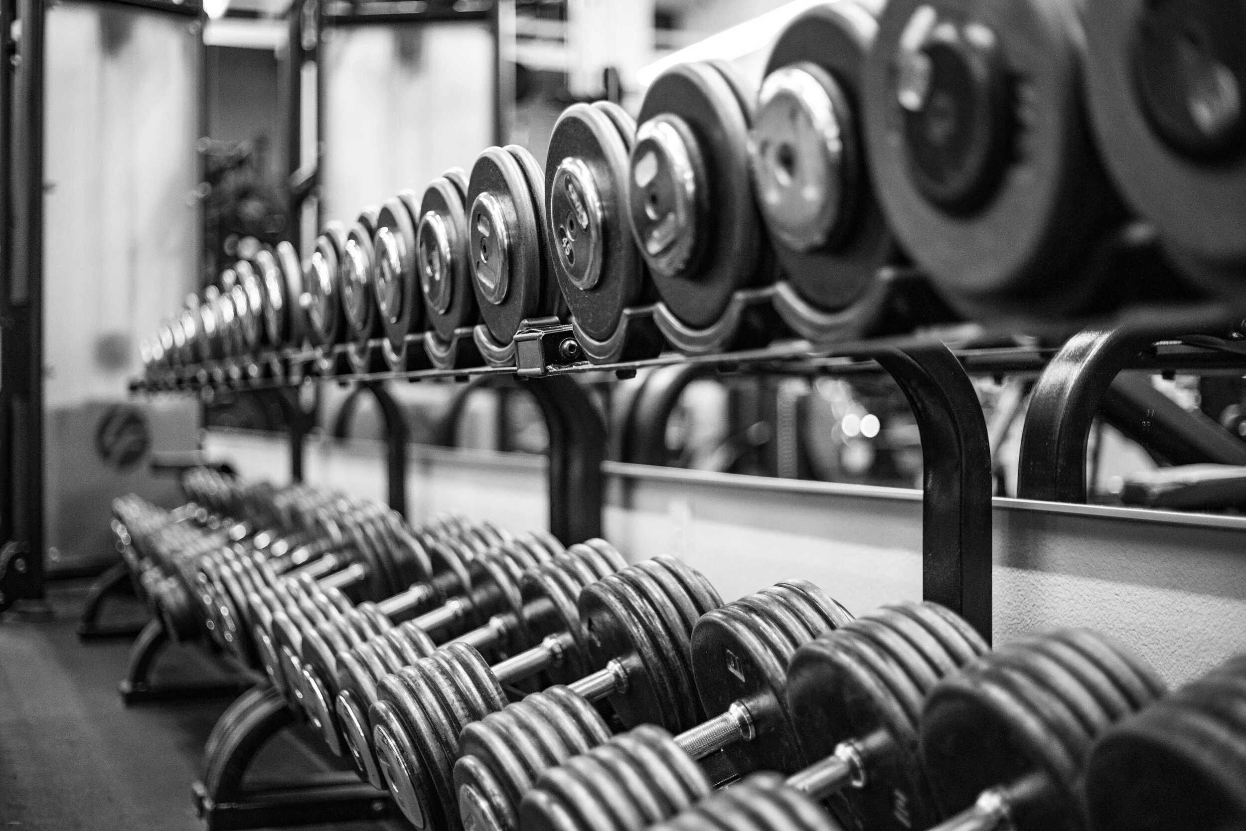 Gym dumbbells weight rack background